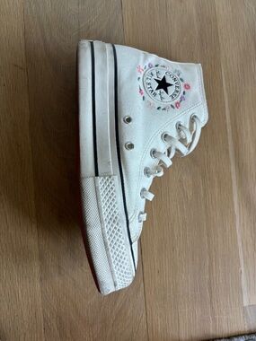 Converse white high tops with embroidered flowers